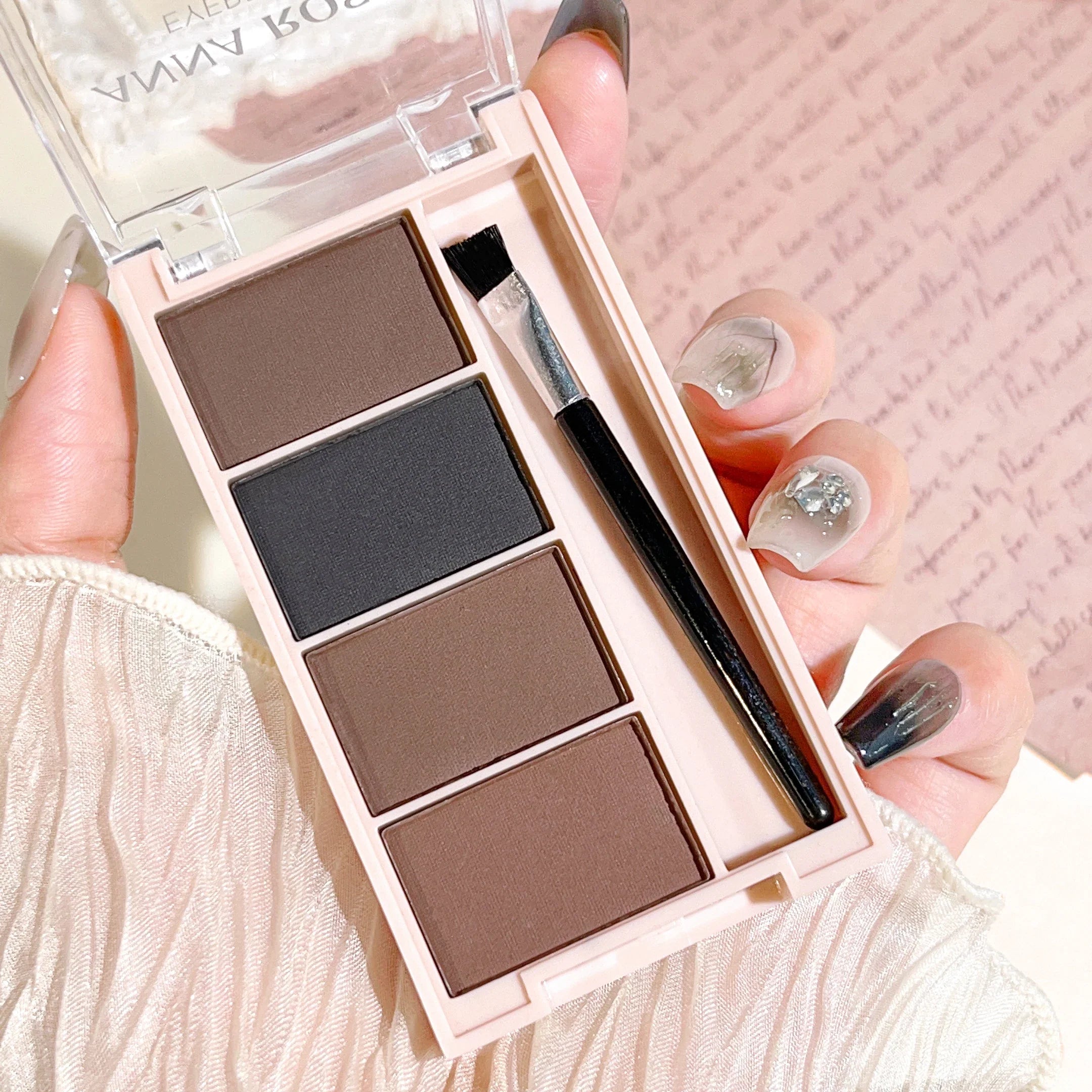 A set of 4-color eyebrow powder trays with brushes in gray and brown matte tones for long-lasting color rendering, filling and s