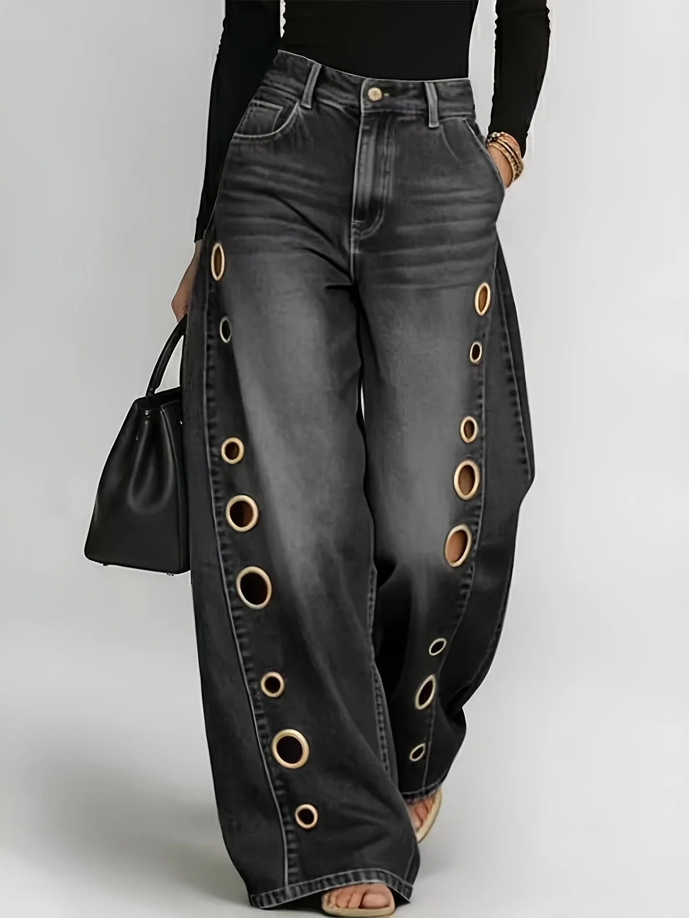 Retro-style wide-leg jeans with metallic eyelets, high-waisted, loose, floor-length fit, gradient eyelets of varying...